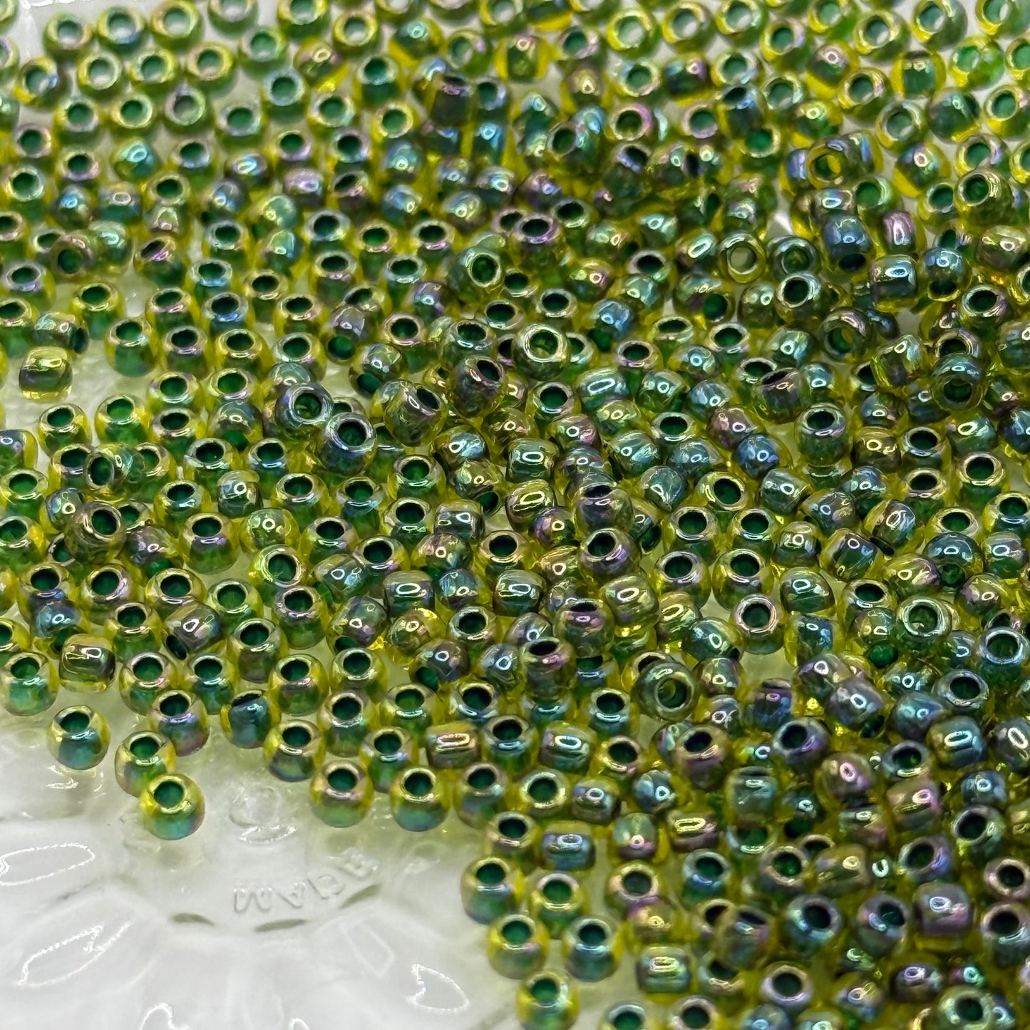 TOHO - Rainbow Jonquil/Forest Green Lined - 11/0